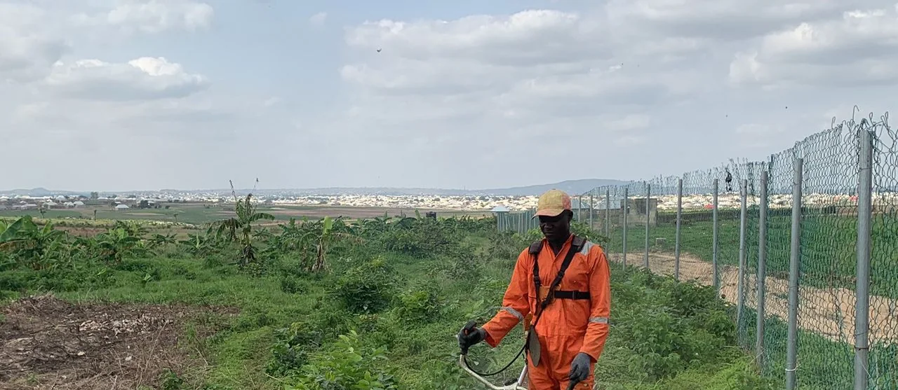 Worker clearing an agricultural pathway